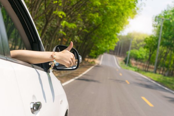 top 10 extended car warranty providers car on the road sunny background hand giving okay sign on the car window